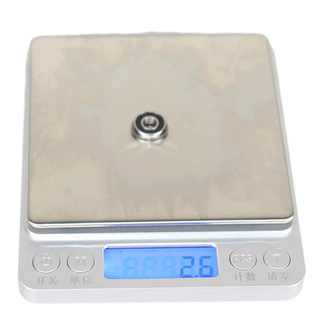 F695-2RS Flanged Ball Bearing ABEC-9 on digital scale showing weight, 5x13x4mm, chrome steel, for high speed motors and 3D printers