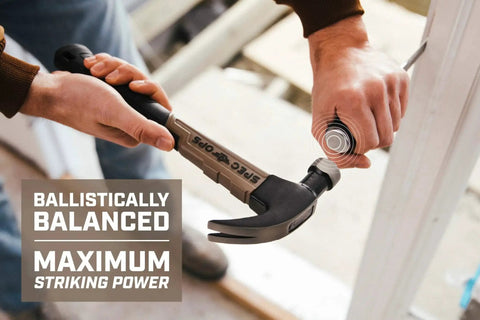 Person holding a Fiberglass 20 Oz Hammer With Smooth Face And Curved Claw, Shock Absorbing MOA Grip, Non Conductive Handle Ideal For Electricians, Carpenters, And Contractors, Lightweight Yet Durable Hammer For Woodworking And Remodeling Projects, ready to use against a surface.