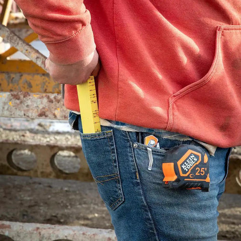 Worker using 6-Foot Folding Ruler 6-Foot Fiberglass With Brick Scale On Reverse And Outside Reading One Sixteenth Inch Graduation Riveted Lock Joints For Woodworking