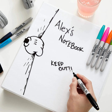 Fine point permanent markers deliver bold, precise lines with quick-drying, odorless ink used on a notebook cover labeled "Alex's Notebook".