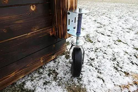 Heavy Duty Flat Free Spring Gate Caster With Universal Mount Eight Inch Wheel on wooden gate outdoors