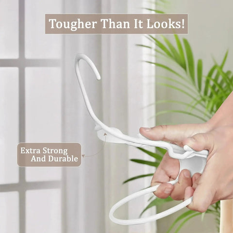 Space saving 50 pack slim plastic hanger being bent, demonstrating durability and strength in a home setting.