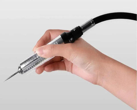 Person holding a Flexible Shaft Grinder Carver Rotary Tool Set with a precision attachment for crafting.