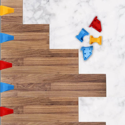 Flooring Spacers Kit With 1/4 Inch And 1/3 Inch Gaps For Wall Positioning, stable triangle design, shown with laminate planks, blue pieces visible
