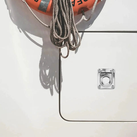 Stainless steel flush pull ring handle installed on boat deck with square mounting plate and four screws