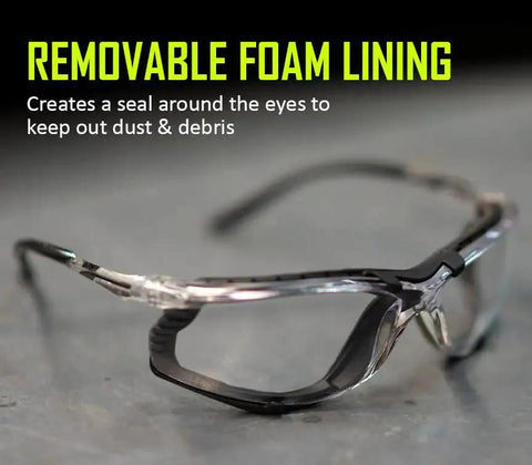 Foam Lined Debris Blocking Safety Glasses With Anti Fog UV Protection ANSI Z87.1 featuring removable foam lining on a table.