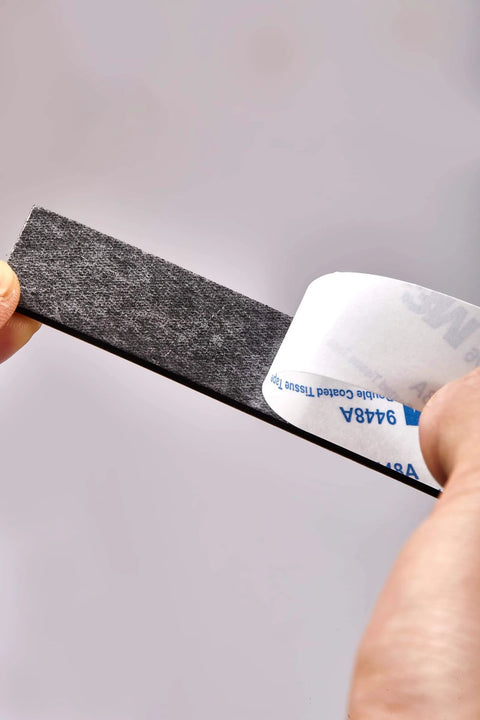 Heavy Duty No Fuss Double Sided Foam Tape Kit with Waterproof Adhesive Mounting Tape being peeled, showing adhesive backing