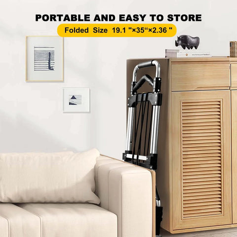 330 LB Capacity Folding Hand Truck Dolly Cart, Portable Aluminum Dolly Cart stored in living room, folded, next to sofa and cabinet.