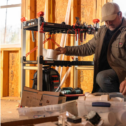 Heavy Duty Folding Jobsite Cart With Three Shelves And 300 Lb Capacity No Assembly Required Pro Grade Tradesman Utility Cart Crescent SiteRunner F3SCBL With 100 Lb Per Shelf Capacity And T Channel Accessory Rail For Easy Tool Attachment in use on a job site with tools and accessories.
