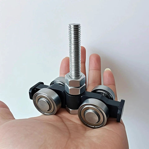 Four Wheel Silent Trolley Rollers Assembly For Unistrut Channel With Hidden Bolt Design Compatible With One And Five Eighths Inch Wide And Taller Strut Channels Black Finish Pack Of Two Designed For Smooth Quiet Operation On Warehouse Racking And shown in hand.