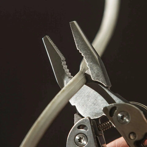 Framework Mini 11 In 1 multitool open frame with needle nose pliers and wire cutters cutting cable in close-up view