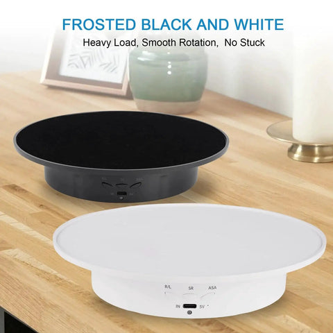 Black and white motorized 360 degree rotating display stands with velvet tops on wooden surface, ideal for jewelry presentation