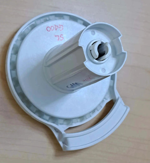 Top view of G400 Galaxy Clutch (White, G400 Hook Mount) laying on a wooden surface, showcasing the spring mechanism.