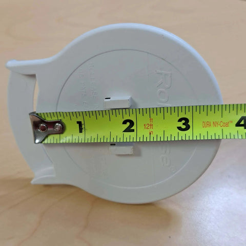 G400 Galaxy Clutch (White, G400 Hook Mount) with tape measure showing size against wooden background.