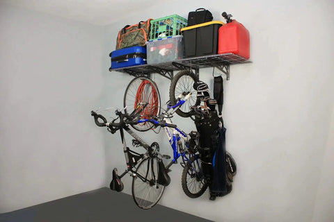 Garage Wall Shelf Two Pack In White Or Hammertone Finish Steel Wall Mounted Shelves With Bike Hooks Three Size Options Including 18x36 Inch Powder Coated Finish 500 Lb Weight Capacity For Overhead And Hanging Storage showing bikes and gear organized.