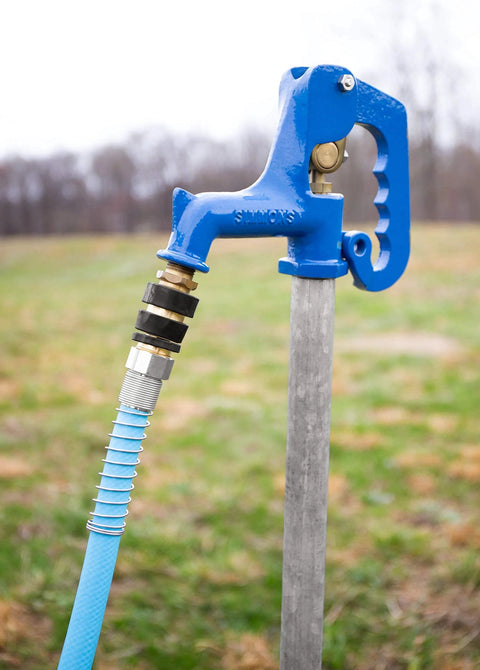 Brass Quick Hose Connect With Auto Shutoff When Disconnected For Garden Hoses attached to a blue outdoor water spigot