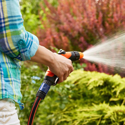 Person using Garden Hose Quick Connectors Set With Four Male And Four Female Fittings And Four Faucet Adapters, 3/4 Inch in garden