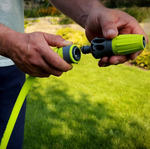 Hands connecting Garden Hose Quick Connect Fittings Kit With Flow-Stop Coupler And Plug in garden setting