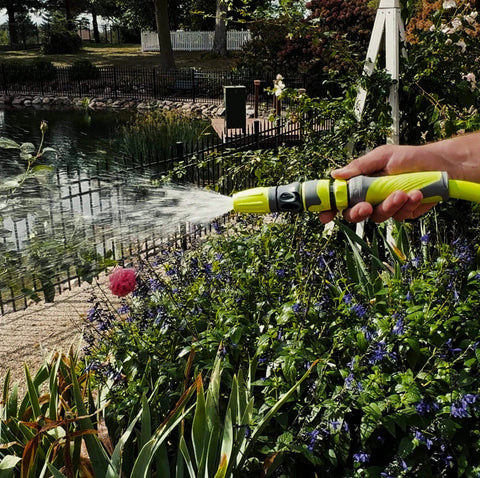 Person using Garden Hose Quick Connect Fittings Kit With Flow-Stop Coupler And Plug - 5-Piece Quick-Connect Set for 3/4 Inch Garden Hoses Standard GHT in a garden