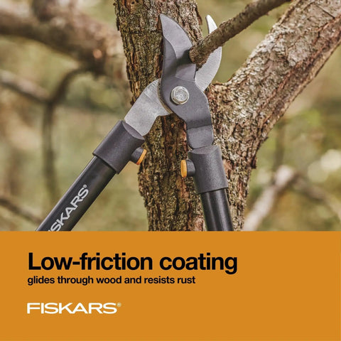 Heavy Duty 28 Inch Garden Loppers With Rust Resistant Bypass Steel Blade cutting a tree branch in a garden setting.