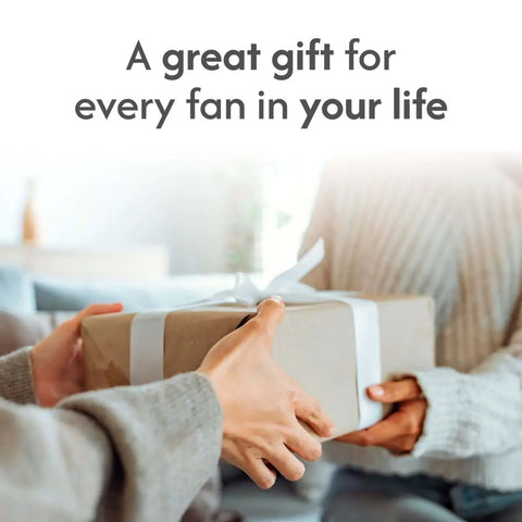 Hands exchanging a gift box with text "A great gift for every fan in your life" in cozy room setting