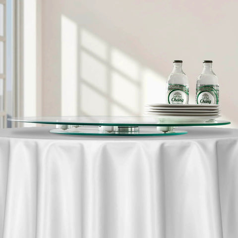 20 Inch Glass Lazy Susan Turntable with bottles and plates on a dining table, round clear tempered glass rotating tray, smooth silent 360 rotation.
