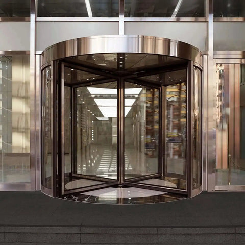 Stainless steel revolving glass door at entrance of modern building