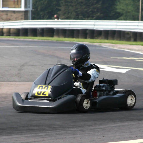 Racer driving a go-kart on a track, equipped with Go Kart Tires and Rims, 10x4.5-5" Go Kart Wheels, Aluminum Alloy Rims
