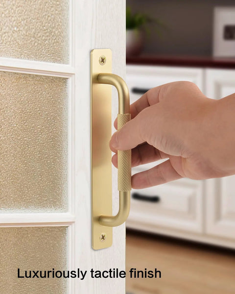 Hand holding a 2 Pack Gold 7 Inch Barn Door Handle For Sliding Closet Doors With Backplates And Drawer Pulls Premium Cabinet Knobs