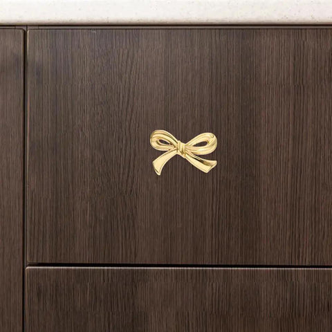 Gold Bow Knobs For Dresser Set Of 4 Brass Drawer Knobs installed on a dark wood cabinet drawer, decorative vintage gold handles