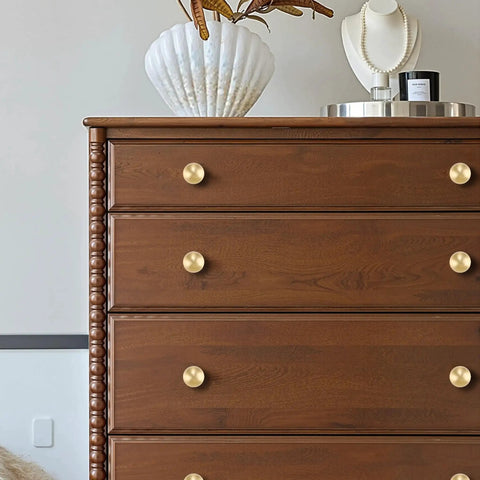 One Inch Gold Ball Cabinet Knobs Set Crafted From Solid Brass With Hand Brushed Finish on wooden dresser