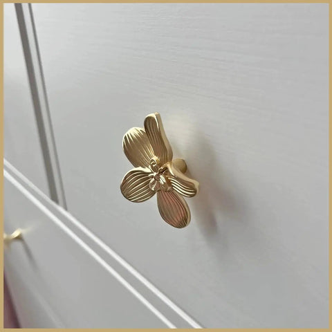 Side view of a Six Pack 2.4 Inch Gold Flower Cabinet Knob on a dresser, featuring a vintage floral petal pull design in elegant gold finish.
