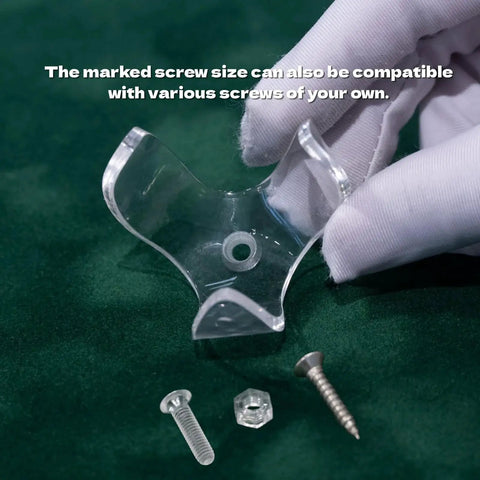 Close-up of transparent acrylic claw for Golf Ball Wall Mount Display with screws on green surface