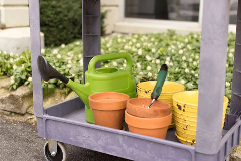 Heavy Duty Service Cart That Hauls Like A Workhorse, 500 Pound Capacity with gardening tools on rust resistant surface