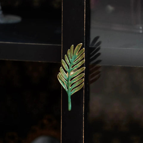 Set Of 2 Metal Green Leaf Cabinet Pulls And Drawer Handles With Simulated Leaf Shape Gradient Color And Glossy Finish installed on a cabinet
