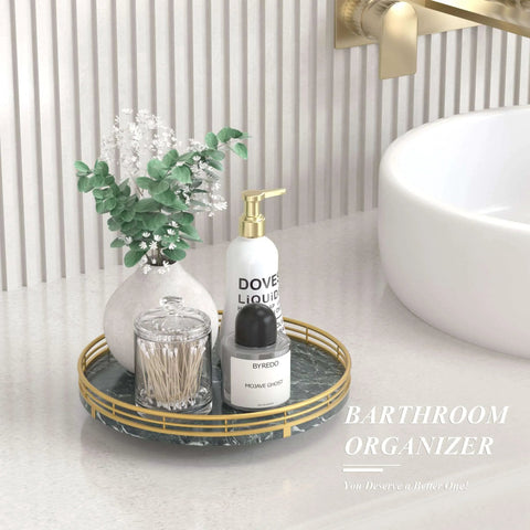Green marble lazy susan turntable for table top, 10 inch round natural marble tray with gold frame on a bathroom countertop.