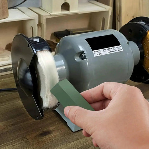 Person using a green compound from triple bar metal polishing kit with 4 oz total on a buffing wheel for smooth finish on metal.