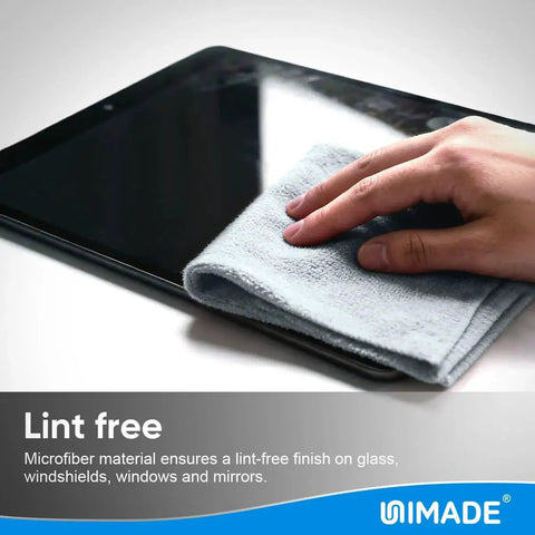 Hand using grey microfiber cleaning cloth to wipe tablet, focus on Microfiber Cleaning Cloths 100 Sheets 11x9 Grey Lint Free For Garage Auto Care