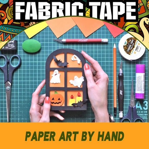 Person crafting Halloween-themed paper art with sticky double sided fabric tape for clothes and leather quick hemming and alterations.