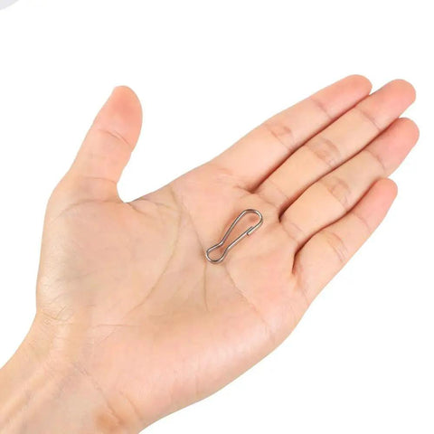 Hand holding a 25mm stainless steel spring hook from 100 Pack 25mm 304 Stainless Steel Spring Hook Clips for Lanyards and Key Chains Rustproof Durable.