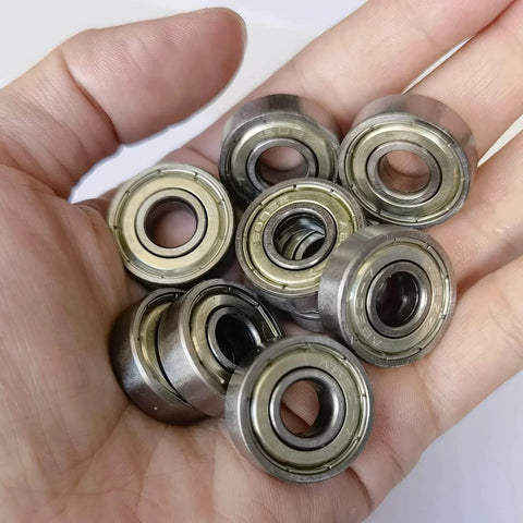 Hand holding 24 PCS 608-ZZ Ball Bearing - Double Metal Sealed Shielded Miniature Deep Groove Bearings