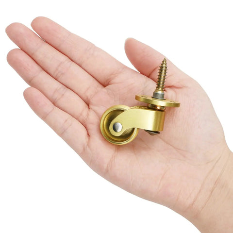 Person holding a Universal Brass Caster Wheels 21mm 360 Degree Swivel Stem Casters Set Of 4 With 12 Screws Heavy Duty Furniture Replacement