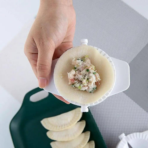 Hand holding No Fuss Dumpling Maker Press Kit 3Pcs small nonstick plastic dumpling mold with filling, showcasing use for pierogi.
