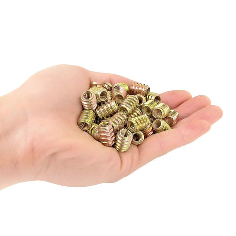 Hand holding 80 Piece M6 Wood Nut Inserts Set With Flush Surface Install Hex Socket Drive M6x15mm for furniture DIY