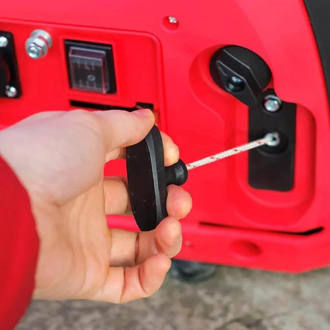 Hand pulling the Two Pack Garage Door Emergency Release Pull Rope Kit with plastic handle for attic door and ladder access