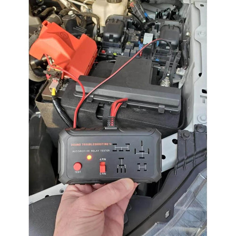 Automotive Relay Tester Kit 12V Handheld Diagnostic Tool for 4 and 5 Pin Relays with Battery Clips in a car engine bay