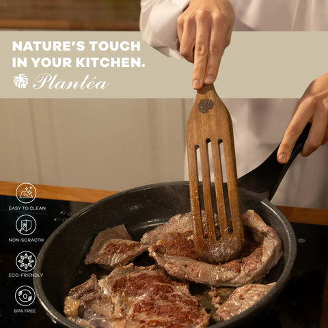 Spurtle Kitchen Tools Wooden Set For Nonstick Cookware in use with acacia wooden spatula flipping steaks in a frying pan.