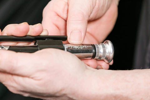 Hands adjusting 9-Inch Reversible Wire Twister Pliers with Auto Spring Loaded Return for Stainless Steel Safety Wire.