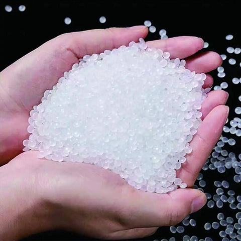Hands holding HDPE white plastic welding rod pellets, material for DIY car bumper repair, water tanks, canoes, and plastic bins patch jobs.