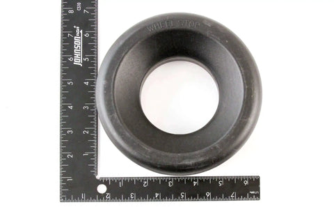 Heavy Duty Trailer Wheel Chock Donut for RVs Campers Boats and Trailers, 6 and a Quarter Inch Outer Diameter, 3 Inch Inner, High Density Polyethylene next to rulers